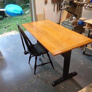 Trestle table with curly top