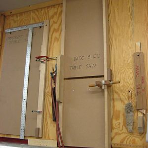 Table saw jigs hanging on wall