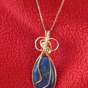 Lapis cabachon wrapped with gold wire