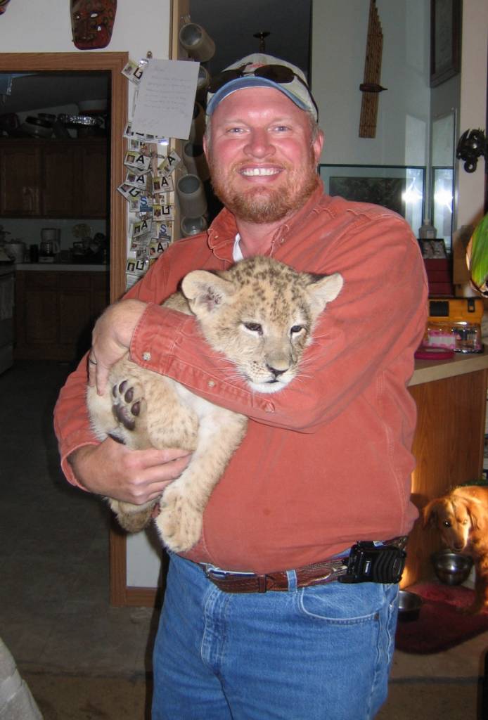 Scott with lion cub