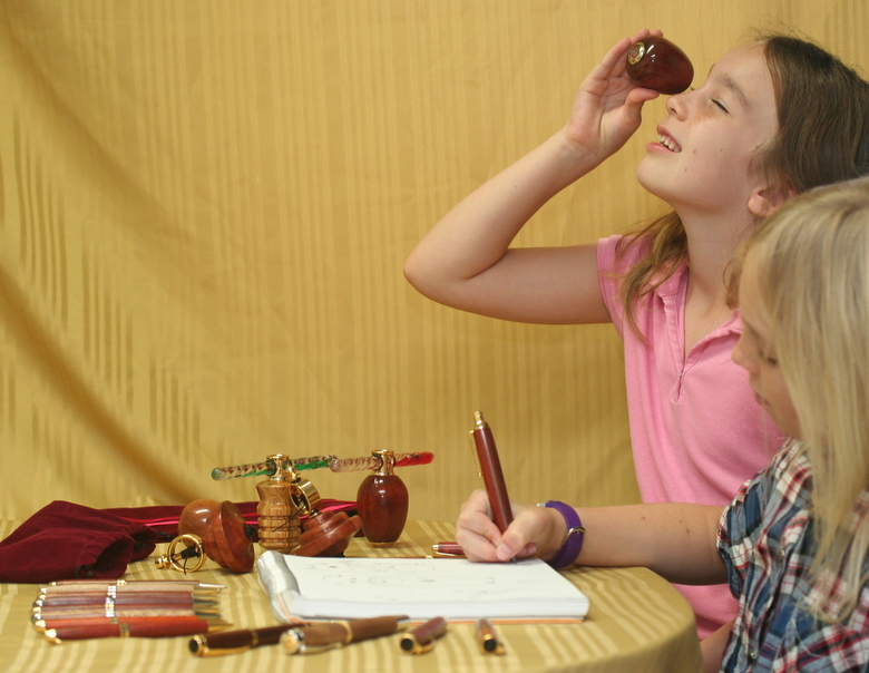 Children eagerly use the artist pencil and kaleidoscopes